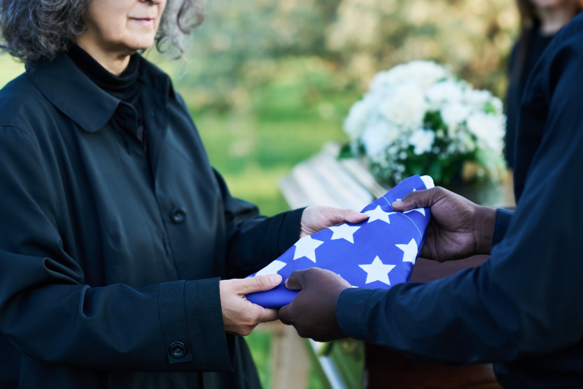 A folded American flag being presented to a veteran's family